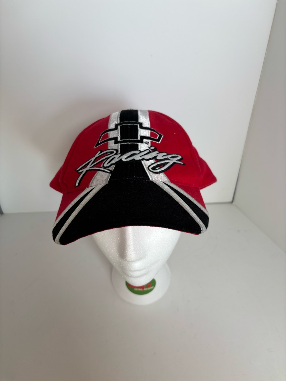 Red, black, and white NASCAR racing cap with Chevrolet logo